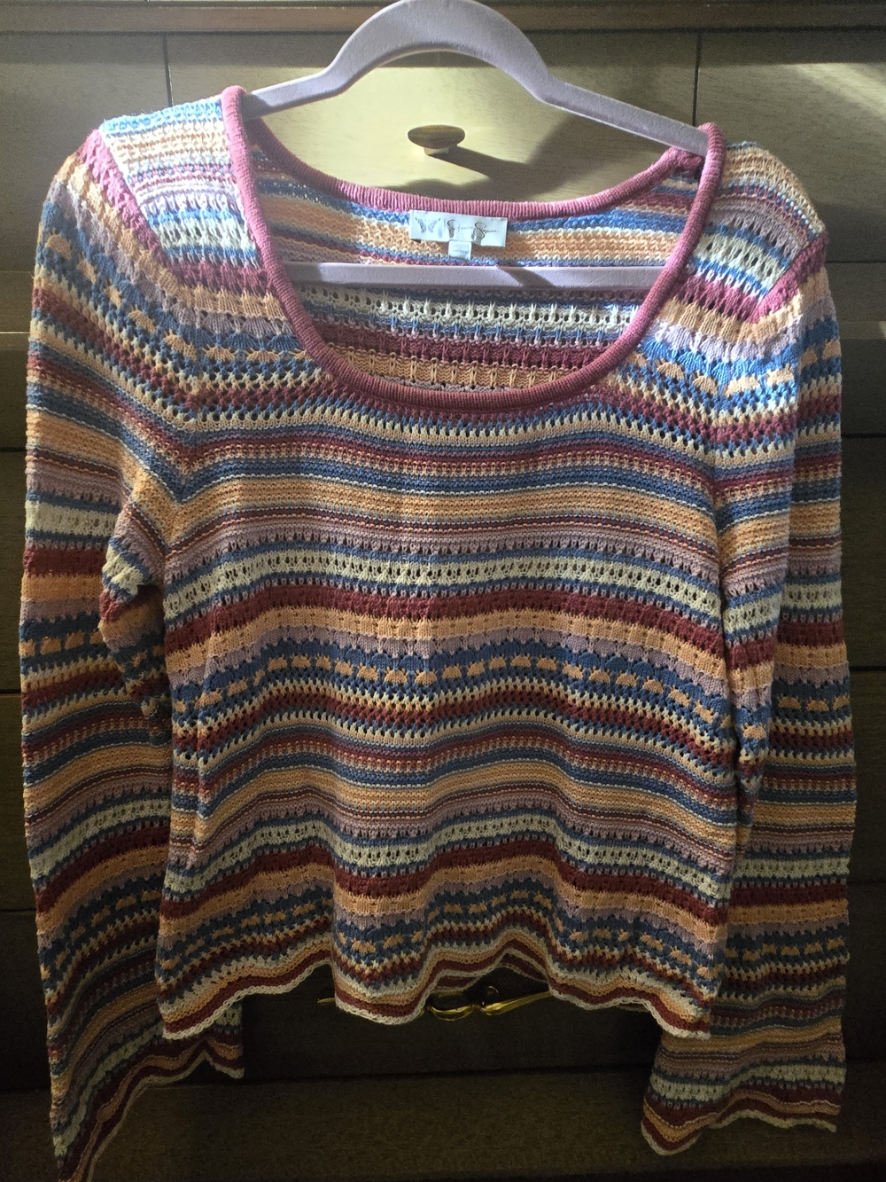 A lightweight multicolor striped knit sweater with a relaxed fit. Features soft